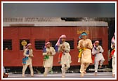 Children performing dances during the train journey
